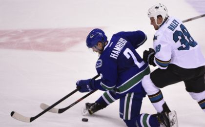 Mar 29, 2016; Vancouver, British Columbia, CAN; Vancouver Canucks defenseman Dan Hamhuis (2) defends San Jose Sharks forward Micheal Haley (38) during the second period at Rogers Arena. Mandatory Credit: Anne-Marie Sorvin-USA TODAY Sports