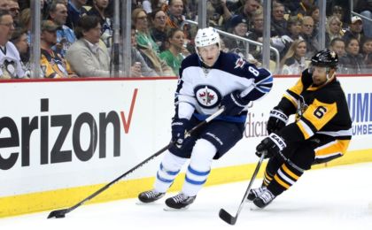 Feb 27, 2016; Pittsburgh, PA, USA; Winnipeg Jets defenseman Jacob Trouba (8) handles the puck Pittsburgh Penguins defenseman Trevor Daley (6) chases during the first period at the CONSOL Energy Center. Mandatory Credit: Charles LeClaire-USA TODAY Sports