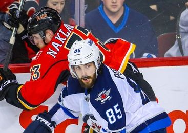Mar 16, 2016; Calgary, Alberta, CAN; Winnipeg Jets center Mathieu Perreault (85) and Calgary Flames defenseman Jakub Nakladal (33) during the third period at Scotiabank Saddledome. Calgary Flames won 4-1. Mandatory Credit: Sergei Belski-USA TODAY Sports