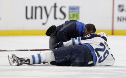Jan 7, 2017; Buffalo, NY, USA; A trainer attends to Winnipeg Jets right wing Patrik Laine (29) after being checked by Buffalo Sabres defenseman Jake McCabe (not shown) during the third period at KeyBank Center. Buffalo beats Winnipeg 4 to 3. Mandatory Credit: Timothy T. Ludwig-USA TODAY Sports