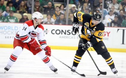 Mar 17, 2016; Pittsburgh, PA, USA; Pittsburgh Penguins center Sidney Crosby (87) moves the puck as Carolina Hurricanes left wing Phil Di Giuseppe (34) pressures during the second period at the CONSOL Energy Center. Mandatory Credit: Charles LeClaire-USA TODAY Sports
