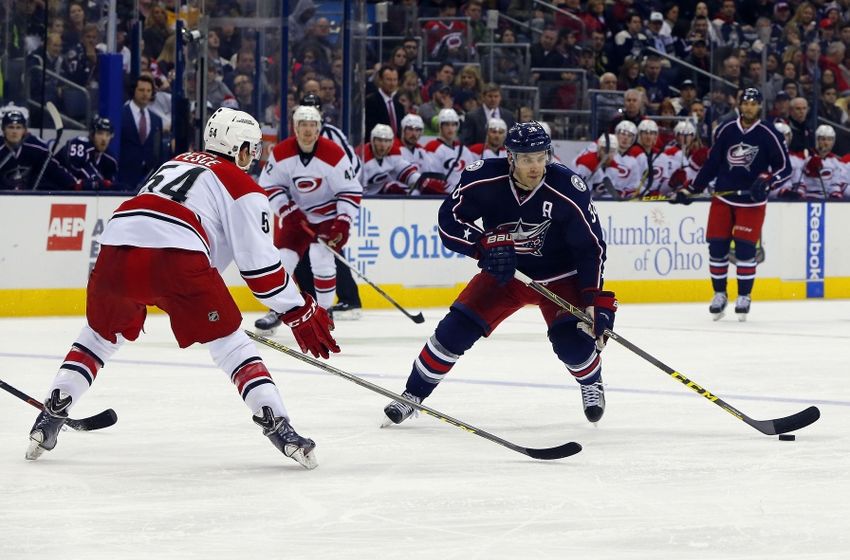 Jan 9, 2016; Columbus, OH, USA; Columbus Blue Jackets center Boone Jenner (38) carries the puck as Carolina Hurricanes defenseman Brett Pesce (54) defends during the second period at Nationwide Arena. Mandatory Credit: Russell LaBounty-USA TODAY Sports