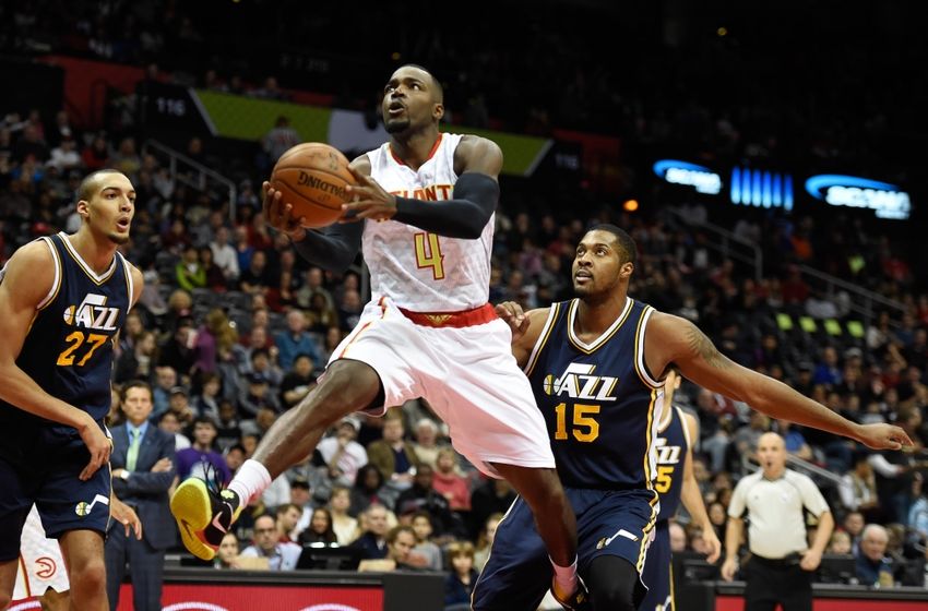 Nov 15, 2015; Atlanta, GA, USA; Atlanta Hawks forward Paul Millsap (4) goes to the basket past Utah Jazz forward Derrick Favors (15) during the first half at Philips Arena. Mandatory Credit: Dale Zanine-USA TODAY Sports