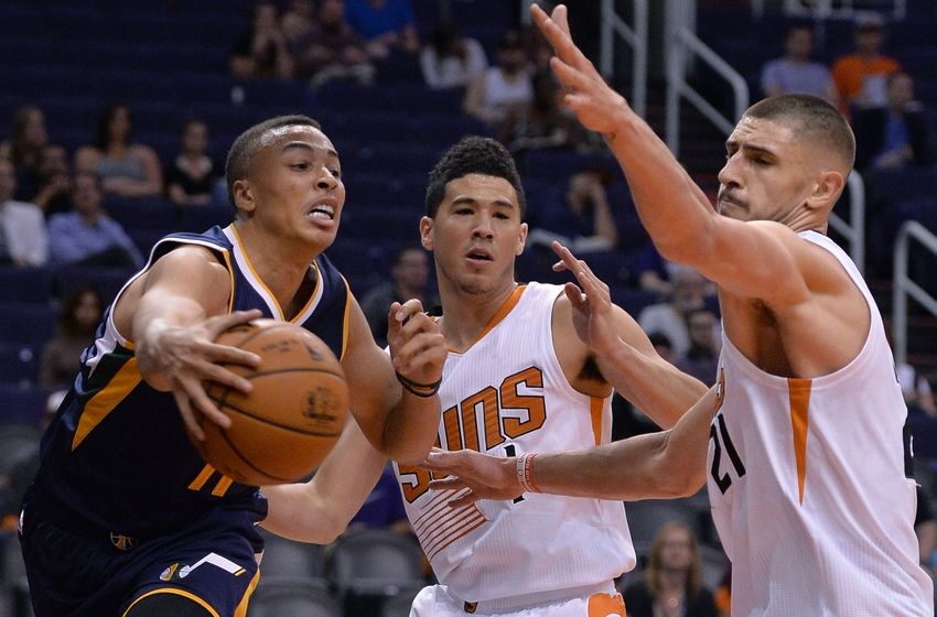 Oct 5, 2016; Phoenix, AZ, USA; Utah Jazz guard Dante Exum (11) makes a pass against Phoenix Suns guard Devin Booker (1) and center Alex Len (21) in the first half at Talking Stick Resort Arena. Mandatory Credit: Jennifer Stewart-USA TODAY Sports