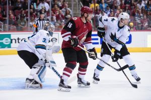 Oct 2, 2015; Glendale, AZ, USA; Arizona Coyotes center Max Domi (16) looks for the puck as San Jose Sharks goalie Martin Jones (31) and defenseman Paul Martin (7) defend during the second period at Gila River Arena. Mandatory Credit: Matt Kartozian-USA TODAY Sports