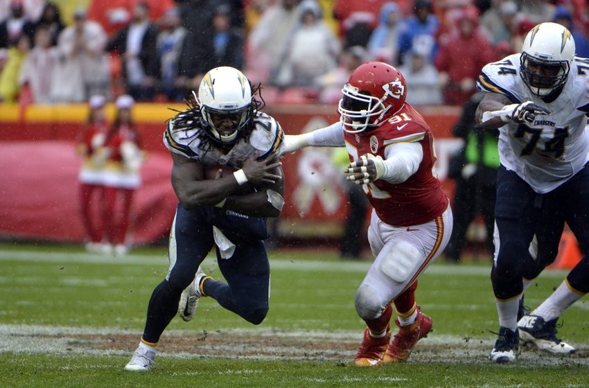 Dec 13, 2015; Kansas City, MO, USA; San Diego Chargers running back Melvin Gordon (28) is tackled by Kansas City Chiefs outside linebacker Tamba Hali (91) in the first half at Arrowhead Stadium. Mandatory Credit: John Rieger-USA TODAY Sports