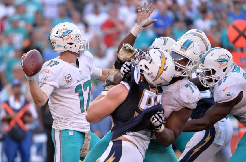 Nov 13, 2016; San Diego, CA, USA; Miami Dolphins quarterback Ryan Tannehill (17) throws a pass as he is pressured by San Diego Chargers defensive end Joey Bosa (99) during the second half at Qualcomm Stadium. Miami won 31-24. Mandatory Credit: Orlando Ramirez-USA TODAY Sports