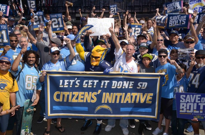 Apr 23, 2016; San Diego, CA, USA; San Diego Chargers fan Dan Jauregui aka Boltman poses with Charger fans during rally to gather signatures for citizen