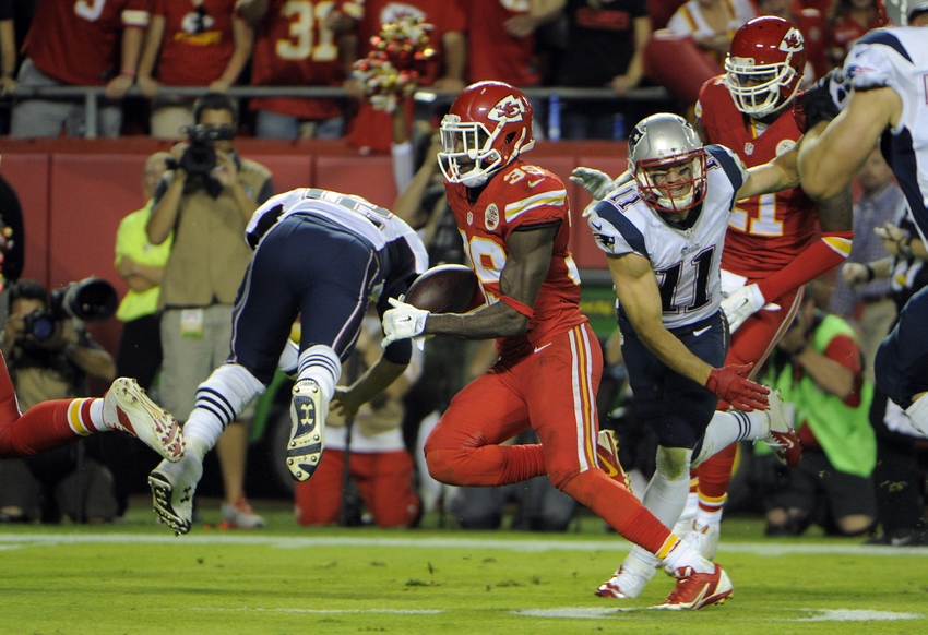 Sep 29, 2014; Kansas City, MO, USA; Kansas City Chiefs free safety Husain Abdullah (39) returns an interception for a touchdown against New England Patriots quarterback Tom Brady (12) in the second half at Arrowhead Stadium. Kansas City won 41-14. Mandatory Credit: John Rieger-USA TODAY Sports