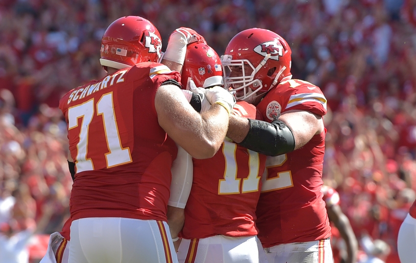 Sep 11, 2016; Kansas City, MO, USA; Kansas City Chiefs quarterback Alex Smith (11) is congratulated by offensive lineman Mitchell Schwartz (71) and wide receiver Albert Wilson (12) after scoring the winning touchdown in overtime against the San Diego Chargers at Arrowhead Stadium. The Chiefs won 33-27 in overtime. Mandatory Credit: Denny Medley-USA TODAY Sports