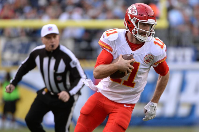 Jan 1, 2017; San Diego, CA, USA; Kansas City Chiefs quarterback Alex Smith (11) runs the ball as referee Walt Anderson (left) follows during the first half of the game against the San Diego Chargers at Qualcomm Stadium. Mandatory Credit: Orlando Ramirez-USA TODAY Sports