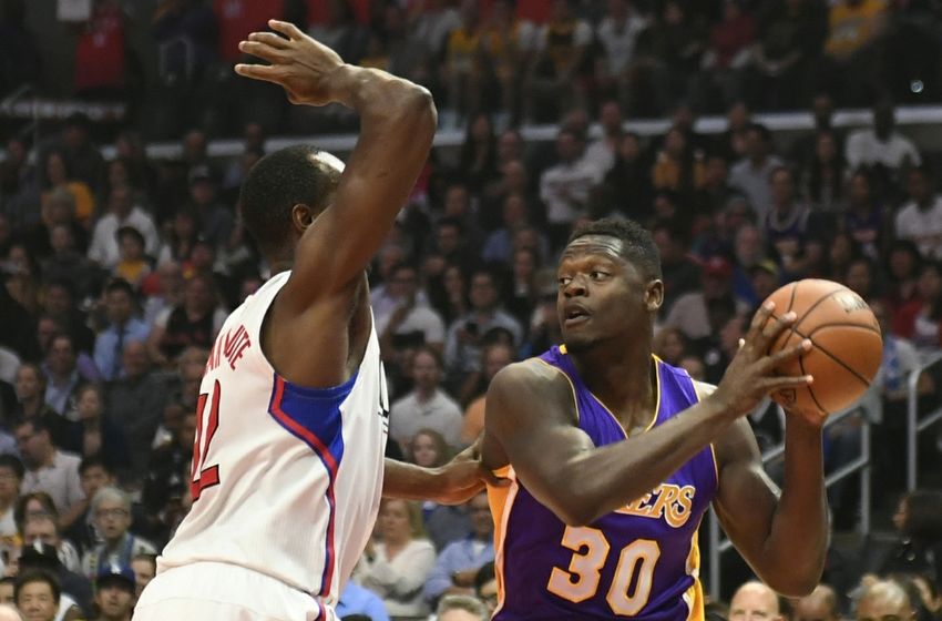 Apr 5, 2016; Los Angeles, CA, USA; Los Angeles Clippers forward Luc Richard Mbah a Moute (12) ) defends against Los Angeles Lakers forward Julius Randle (30) during the first half at Staples Center. Mandatory Credit: Richard Mackson-USA TODAY Sports