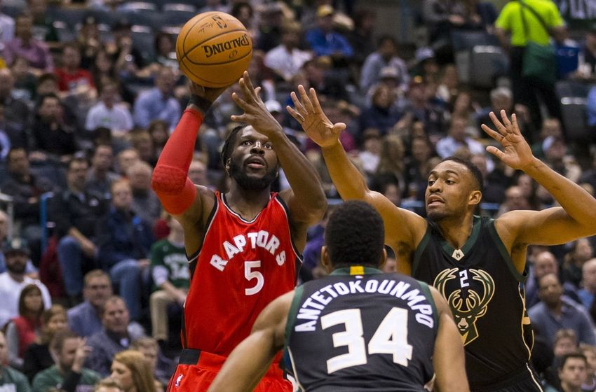 Nov 25, 2016; Milwaukee, WI, USA; Toronto Raptors forward DeMarre Carroll (5) shoots between Milwaukee Bucks forward Giannis Antetokounmpo (34) and forward Jabari Parker (12) during the first quarter at BMO Harris Bradley Center. Mandatory Credit: Jeff Hanisch-USA TODAY Sports
