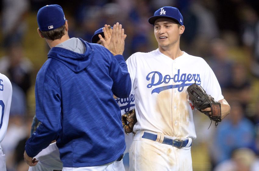 Oct 18, 2016; Los Angeles, CA, USA; Los Angeles Dodgers shortstop Corey Seager (5) and starting pitcher Rich Hill (44) celebrate beating the Chicago Cubs in game three of the 2016 NLCS playoff baseball series at Dodger Stadium. Mandatory Credit: Gary A. Vasquez-USA TODAY Sports
