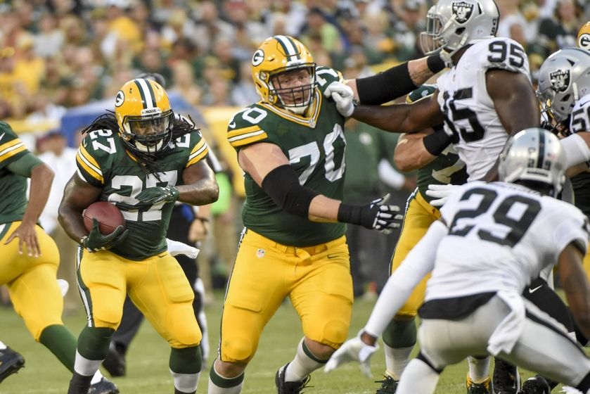Green Bay Packers running back Eddie Lacy (27) follows a block by guard T.J. Lang (70) in the first quarter during the game against the Oakland Raiders at Lambeau Field.