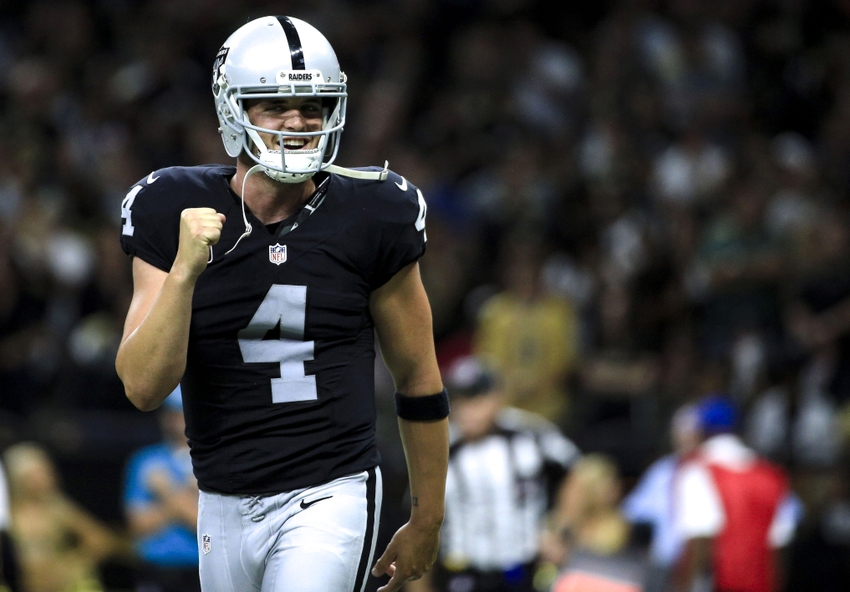 Oakland Raiders quarterback Derek Carr (4) celebrates after completing a two point conversion to take the lead during the fourth quarter of a game against the New Orleans Saints at the Mercedes-Benz Superdome. The Raiders defeated the Saints 35-34.