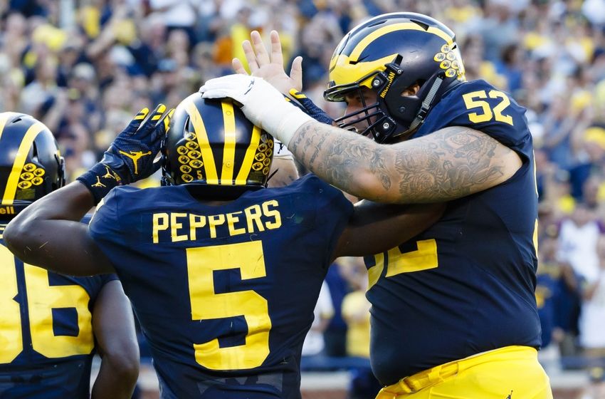 Sep 17, 2016; Ann Arbor, MI, USA; Michigan Wolverines linebacker Jabrill Peppers (5) receives congratulations from offensive lineman Mason Cole (52) after he scores a touchdown in the second half against the Colorado Buffaloes at Michigan Stadium. Michigan won 45-28. Mandatory Credit: Rick Osentoski-USA TODAY Sports