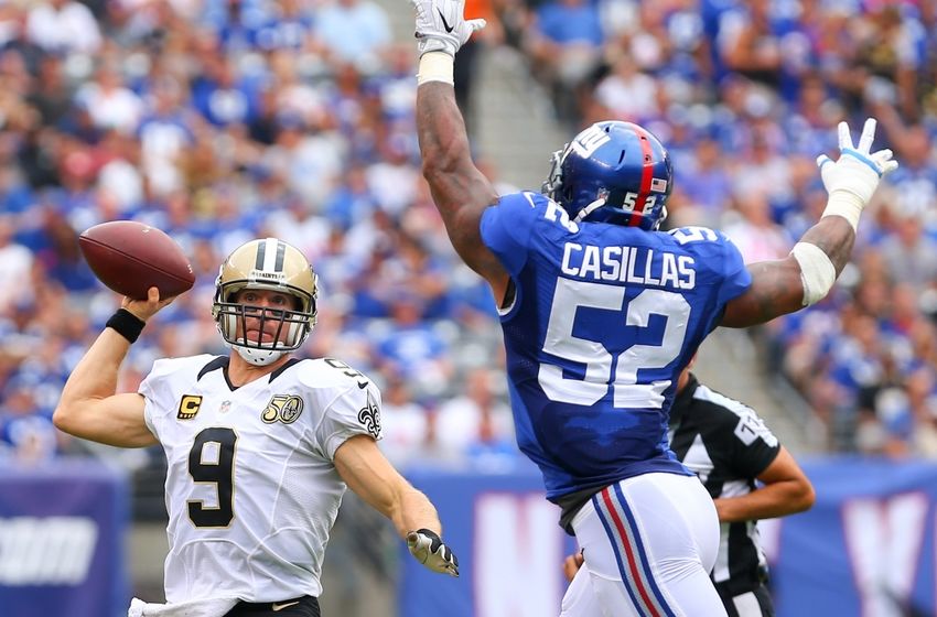 Sep 18, 2016; East Rutherford, NJ, USA; New Orleans Saints quarterback Drew Brees (9) runs out of the pocket to avoid New York Giants outside linebacker Jonathan Casillas (52) during the first half at MetLife Stadium. Mandatory Credit: Ed Mulholland-USA TODAY Sports