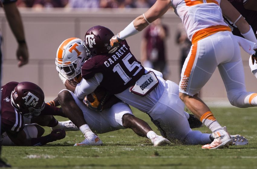 Oct 8, 2016; College Station, TX, USA; Texas A&M Aggies defensive lineman Myles Garrett (15) tackles Tennessee Volunteers quarterback Joshua Dobbs (11) during the first quarter at Kyle Field. Mandatory Credit: Jerome Miron-USA TODAY Sports