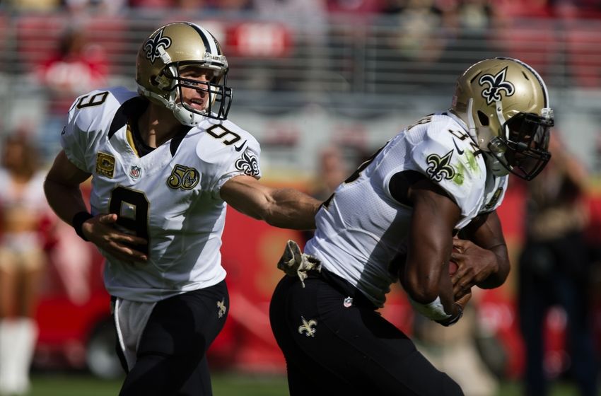 Nov 6, 2016; Santa Clara, CA, USA; New Orleans Saints quarterback Drew Brees (9) hands off to running back Tim Hightower (34) against the San Francisco 49ers during the first quarter at Levi