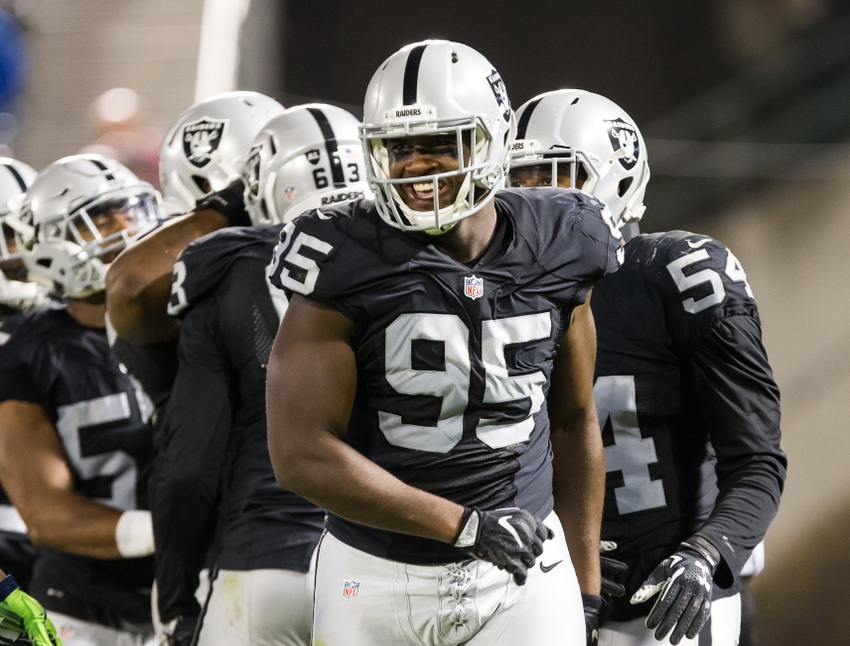 Oakland Raiders defensive end Jihad Ward (95) smiles after a play against the Seattle Seahawks during the second quarter at Oakland Coliseum.