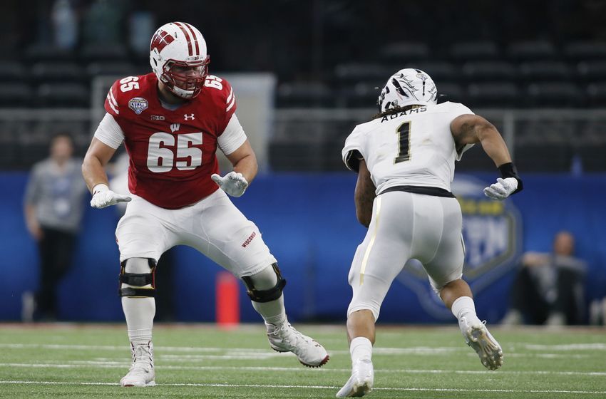 Jan 2, 2017; Arlington, TX, USA; Wisconsin Badgers offensive lineman Ryan Ramczyk (65) blocks Western Michigan Broncos defensive end Keion Adams (1) in the third quarter at AT&T Stadium. The Badgers won 24-16. Mandatory Credit: Tim Heitman-USA TODAY Sports