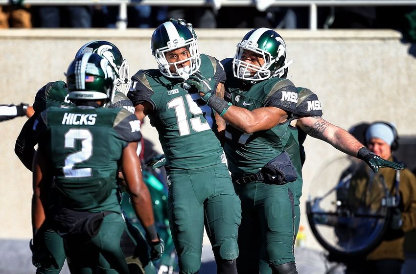 Nov 14, 2015; East Lansing, MI, USA; Michigan State Spartans cornerback Tyson Smith (15) and Michigan State Spartans cornerback Darian Hicks (2) celebrate defense stop during the 1st quarter of a game against the Maryland Terrapins at Spartan Stadium. Mandatory Credit: Mike Carter-USA TODAY Sports