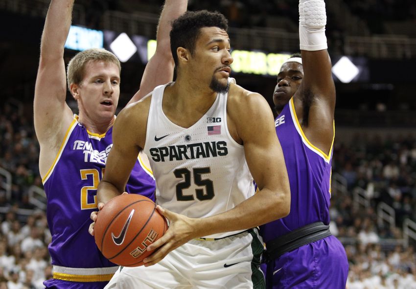 Dec 10, 2016; East Lansing, MI, USA; Michigan State Spartans forward Kenny Goins (25) gets a rebound against Tennessee Tech Golden Eagles forward Mason Ramsey (25) and guard Savonte Frazier (20) during the second half at Jack Breslin Student Events Center. Spartans win 71-63. Mandatory Credit: Raj Mehta-USA TODAY Sports