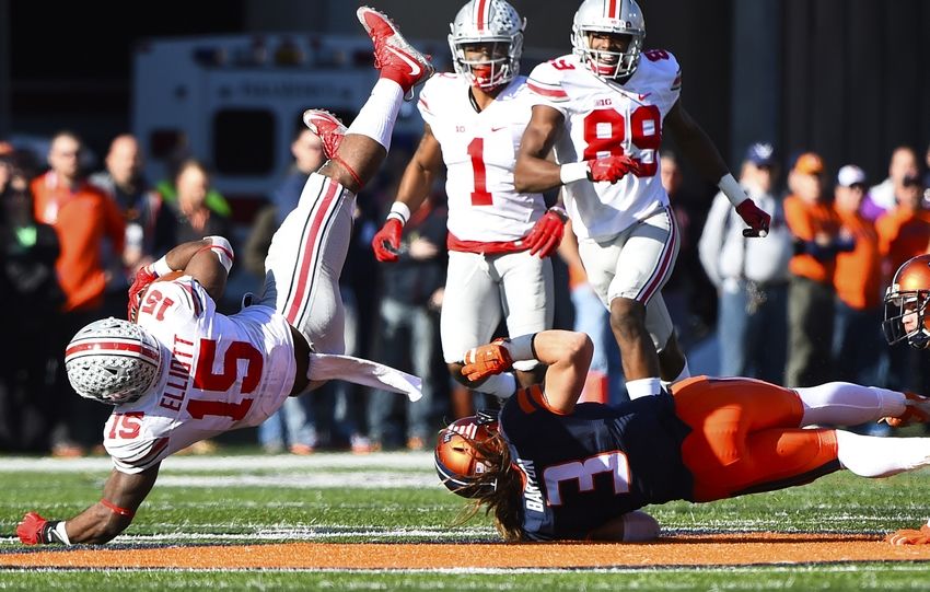 Nov 14, 2015; Champaign, IL, USA; Ohio State Buckeyes running back Ezekiel Elliott (15) is tackled by Illinois Fighting Illini defensive back Taylor Barton (3) during the third quarter at Memorial Stadium. Mandatory Credit: Mike DiNovo-USA TODAY Sports