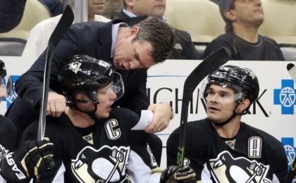 Feb 2, 2016; Pittsburgh, PA, USA; Pittsburgh Penguins head coach Mike Sullivan (rear) talks with center Sidney Crosby (87) and left wing Chris Kunitz (14) on the bench against the Ottawa Senators during the first period at the CONSOL Energy Center. Mandatory Credit: Charles LeClaire-USA TODAY Sports