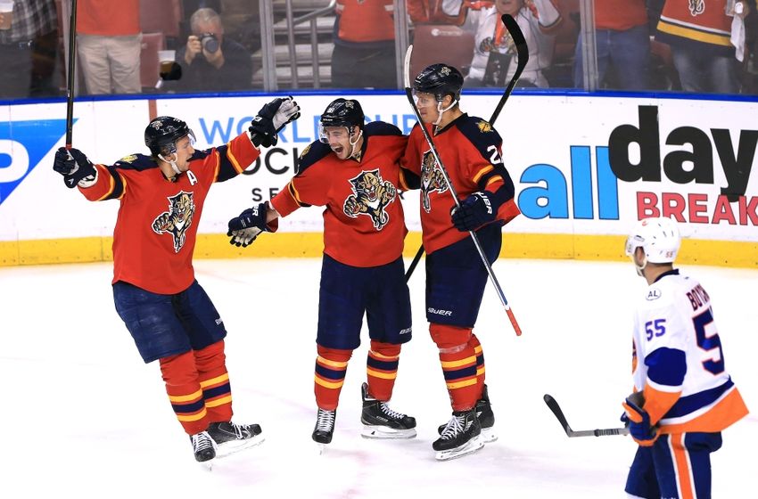 Apr 15, 2016; Sunrise, FL, USA; Florida Panthers center Nick Bjugstad (27) celebrates his goal with right wing Reilly Smith (18) and left wing Jussi Jokinen (36) as New York Islanders defenseman Johnny Boychuk (55) looks on in the second period in game two of the first round of the 2016 Stanley Cup Playoffs at BB&T Center. Mandatory Credit: Robert Mayer-USA TODAY Sports