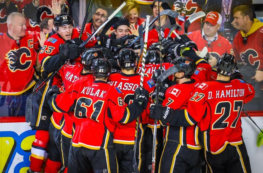Nov 16, 2016; Calgary, Alberta, CAN; Calgary Flames right wing Michael Frolik (67) celebrates his goal with teammates against the Arizona Coyotes during the overtime period at Scotiabank Saddledome. Calgary Flames won 2-1. Mandatory Credit: Sergei Belski-USA TODAY Sports