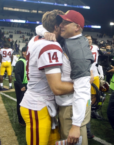 Nov 12, 2016; Seattle, WA, USA; USC Trojans head coach Clay Helton hugs USC Trojans quarterback Sam Darnold (14) following a 26-13 victory against the Washington Huskies at Husky Stadium. Mandatory Credit: Joe Nicholson-USA TODAY Sports