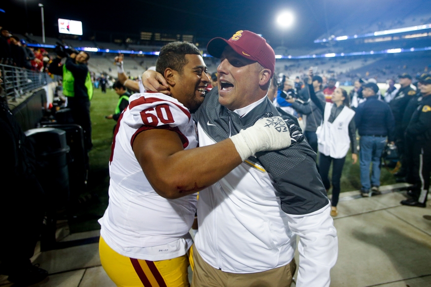 Nov 12, 2016; Seattle, WA, USA; USC Trojans head coach Clay Helton celebrates with guard Viane Talamaivao (60) following a 26-13 victory against the Washington Huskies at Husky Stadium. Mandatory Credit: Joe Nicholson-USA TODAY Sports