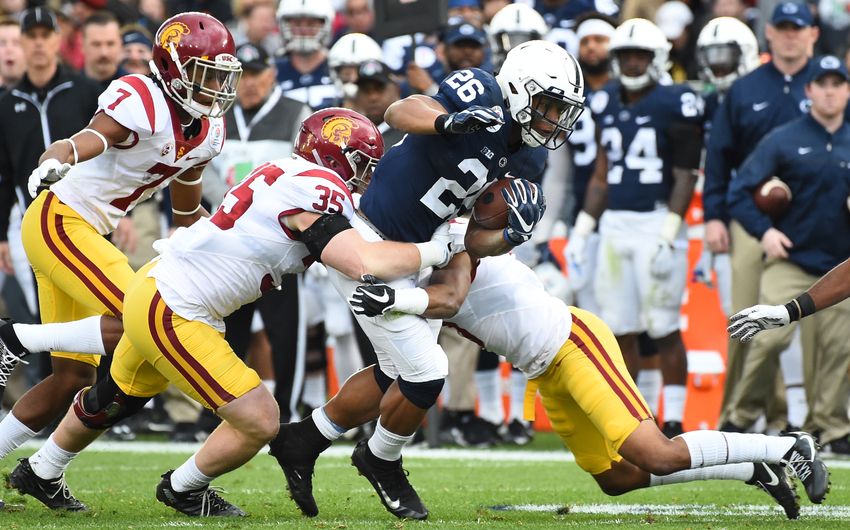 Jan 2, 2017; Pasadena, CA, USA; Penn State Nittany Lions running back Saquon Barkley (26) runs against USC Trojans linebacker Cameron Smith (35) for a 16 yard gain during the second quarter of the 2017 Rose Bowl game at Rose Bowl. Mandatory Credit: Jayne Kamin-Oncea-USA TODAY Sports