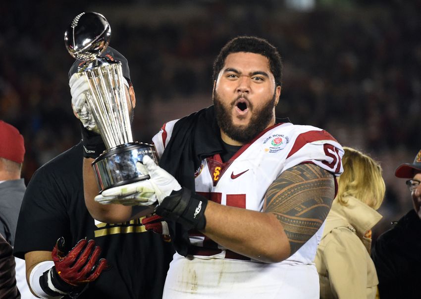 Jan 2, 2017; Pasadena, CA, USA; USC Trojans guard Damien Mama (51) celebrates on the podium with the Rose Bowl trophy after defeating the Penn State Nittany Lions in the 2017 Rose Bowl game at Rose Bowl. Mandatory Credit: Jayne Kamin-Oncea-USA TODAY Sports