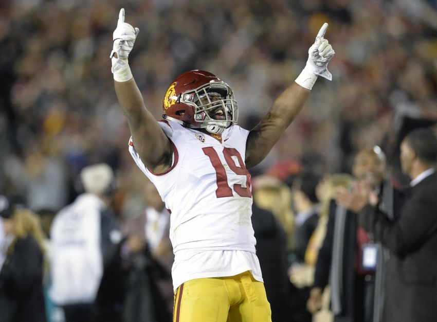 January 2, 2017; Pasadena, CA, USA; Southern California Trojans linebacker Michael Hutchings (19) reacts after defensive back Leon McQuay III (22) intercepts a pass against the Penn State Nittany Lions during the second half of the 2017 Rose Bowl game at the Rose Bowl. Mandatory Credit: Gary A. Vasquez-USA TODAY Sports