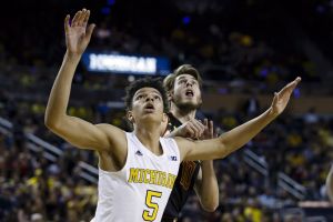Jan 12, 2016; Ann Arbor, MI, USA; Michigan Wolverines forward D.J. Wilson (5) boxes out Maryland Terrapins forward Jake Layman (10) in the second half at Crisler Center. Michigan won 70-67. Mandatory Credit: Rick Osentoski-USA TODAY Sports