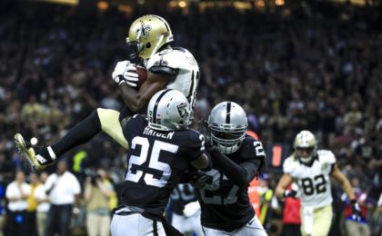 Sep 11, 2016; New Orleans, LA, USA; New Orleans Saints wide receiver Brandin Cooks (10) catches a touchdown pass over Oakland Raiders cornerback D.J. Hayden (25) and defensive back Reggie Nelson (27) during the second quarter of a game at the Mercedes-Benz Superdome. Mandatory Credit: Derick E. Hingle-USA TODAY Sports