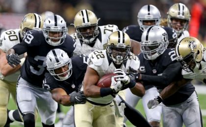 Sep 11, 2016; New Orleans, LA, USA; New Orleans Saints running back Mark Ingram (22) runs while being chased by a host of Oakland Raiders defenders in the fourth quarter at the Mercedes-Benz Superdome. The Raiders won 35-34. Mandatory Credit: Chuck Cook-USA TODAY Sports