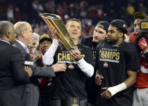 Jan 12, 2015; Arlington, TX, USA; Ohio State Buckeyes head coach Urban Meyer celebrates with the college football championship trophy after beating the Oregon Ducks in the 2015 CFP National Championship Game at AT&T Stadium. Mandatory Credit: Tommy Gilligan-USA TODAY Sports