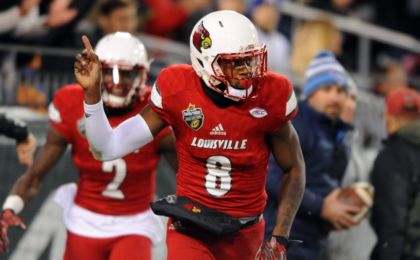 Dec 30, 2015; Nashville, TN, USA; Louisville Cardinals quarterback Lamar Jackson (8) celebrates after a 62-yard touchdown run during the first half against the Texas A&M Aggies in the 2015 Music City Bowl at Nissan Stadium. Mandatory Credit: Christopher Hanewinckel-USA TODAY Sports