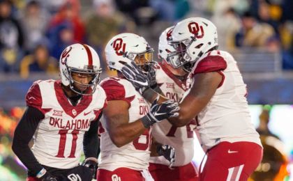 Nov 19, 2016; Morgantown, WV, USA; Oklahoma Sooners running back Samaje Perine (32) celebrates with teammates after scoring a touchdown during the second quarter against the West Virginia Mountaineers at Milan Puskar Stadium. Mandatory Credit: Ben Queen-USA TODAY Sports
