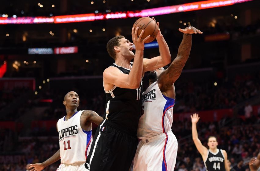 Feb 29, 2016; Los Angeles, CA, USA; Brooklyn Nets center Brook Lopez (11) is defended by Los Angeles Clippers guard Jamal Crawford (11) and center DeAndre Jordan (6) during an NBA game at the Staples Center. Mandatory Credit: Kirby Lee-USA TODAY Sports