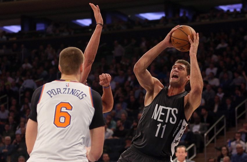 Nov 9, 2016; New York, NY, USA; Brooklyn Nets center Brook Lopez (11) shoots against New York Knicks center Joakim Noah (13) and New York Knicks power forward Kristaps Porzingis (6) during the second quarter at Madison Square Garden. Mandatory Credit: Brad Penner-USA TODAY Sports