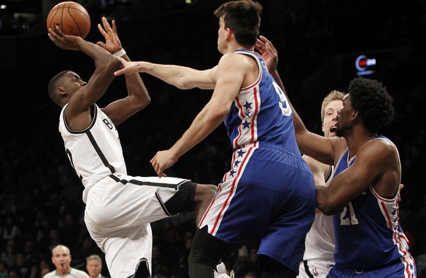 Jan 8, 2017; Brooklyn, NY, USA; Brooklyn Nets guard Caris LeVert (22) puts up a shot against Philadelphia 76ers forward Dario Saric (9) in the fourth quarter at Barclays Center. Sixers win 105-95. Mandatory Credit: Nicole Sweet-USA TODAY Sports