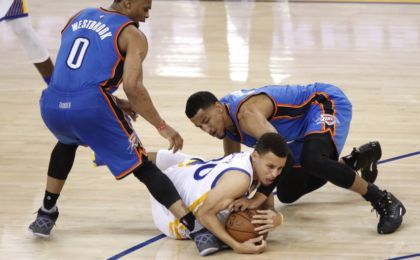 May 18, 2016; Oakland, CA, USA; Golden State Warriors guard Stephen Curry (30) gains control of a loose ball next to Oklahoma City Thunder guard Andre Roberson (21) and guard Russell Westbrook (0) in the third quarter in game two of the Western conference finals of the NBA Playoffs at Oracle Arena. Mandatory Credit: Cary Edmondson-USA TODAY Sports