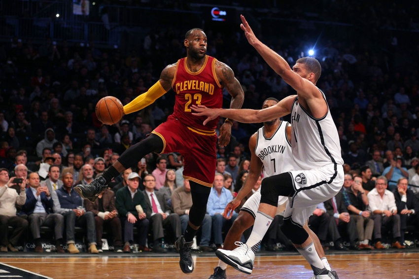Jan 20, 2016; Brooklyn, NY, USA; Cleveland Cavaliers small forward LeBron James (23) passes around Brooklyn Nets center Brook Lopez (11) during the first quarter at Barclays Center. Mandatory Credit: Brad Penner-USA TODAY Sports