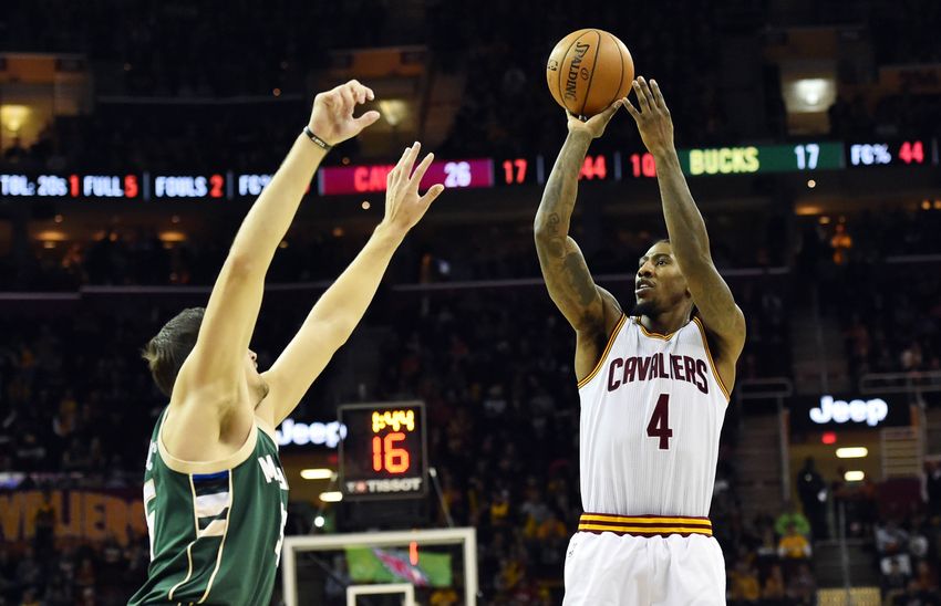 Dec 21, 2016; Cleveland, OH, USA; Cleveland Cavaliers guard Iman Shumpert (4) shoots over the defense of Milwaukee Bucks forward Mirza Teletovic (35) during the first half at Quicken Loans Arena. Mandatory Credit: Ken Blaze-USA TODAY Sports