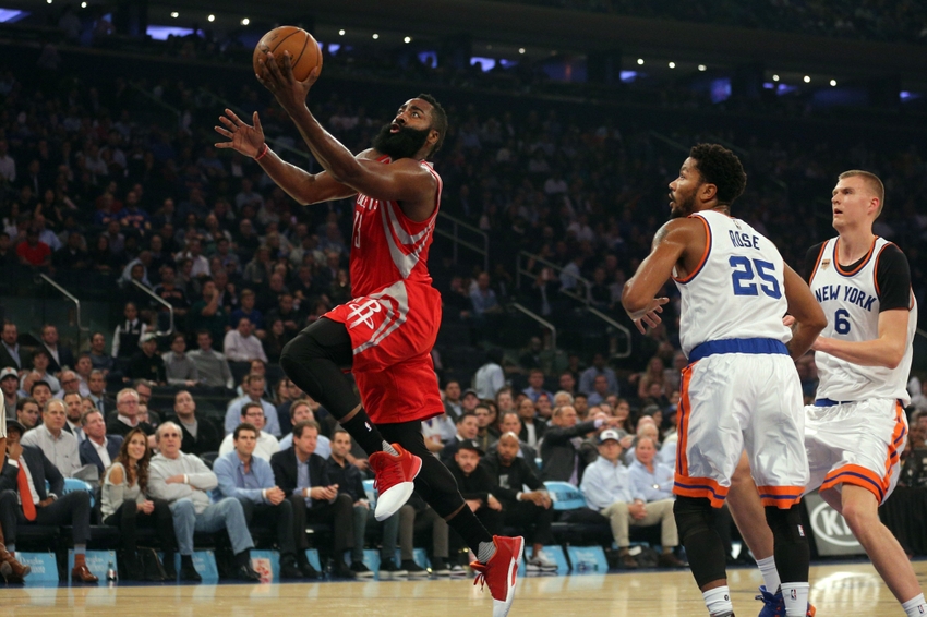 Nov 2, 2016; New York, NY, USA; Houston Rockets shooting guard James Harden (13) drives past New York Knicks point guard Derrick Rose (25) and New York Knicks power forward Kristaps Porzingis (6) during the first quarter at Madison Square Garden. Mandatory Credit: Brad Penner-USA TODAY Sports